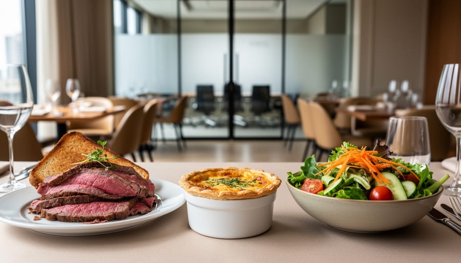 Close-up of a modern lunch plate with roast beef, savory quiche, and a fresh seasonal salad in a clean restaurant dining setting